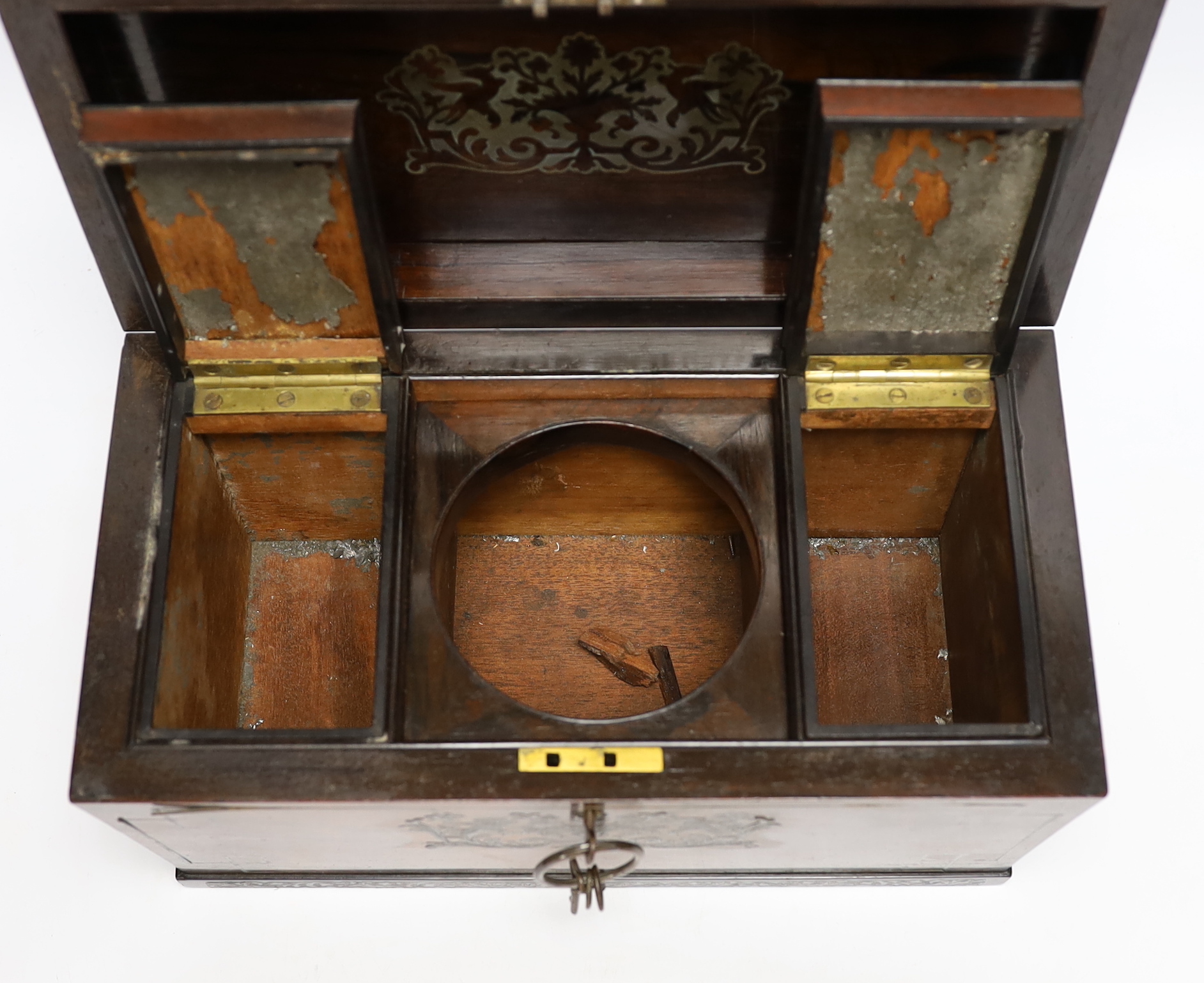 A George IV cut brass inlaid rosewood sarcophagus tea caddy, with keys, 32cm wide